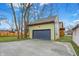 View of the detached garage with a new driveway and well maintained lawn at 6129 Crittenden Ave, Indianapolis, IN 46220
