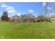 Expansive back yard with lush green grass, deck, and playground at 603 Ophelia Dr, Avon, IN 46123
