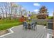 Backyard deck features outdoor dining set and direct access to the yard and playground at 603 Ophelia Dr, Avon, IN 46123