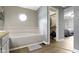 Bright bathroom featuring a corner tub, an octagon window and access to the walk-in closet and bedroom at 603 Ophelia Dr, Avon, IN 46123