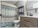 Updated bathroom featuring modern vanity, patterned shower curtain, and unique tile flooring at 603 Ophelia Dr, Avon, IN 46123