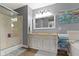 Modern bathroom featuring a shower, a double sink vanity and a large mirror, complemented by warm wood flooring at 603 Ophelia Dr, Avon, IN 46123