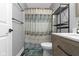 Updated bathroom featuring modern vanity, patterned shower curtain, and unique tile flooring at 603 Ophelia Dr, Avon, IN 46123