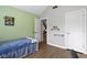 Well-lit bedroom with wood plank flooring, and view into living area, and closet at 603 Ophelia Dr, Avon, IN 46123