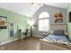Light-filled bedroom features a vaulted ceiling, a large arched window and wood plank flooring at 603 Ophelia Dr, Avon, IN 46123