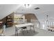 Bonus room with neutral carpet, half wall, white table, and shelving for versatile space at 603 Ophelia Dr, Avon, IN 46123