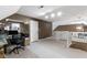 Bright bonus room with neutral carpet, half wall, with desk, and a door to a closet at 603 Ophelia Dr, Avon, IN 46123