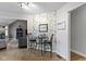 Cozy dining area featuring tile floors, floral wallpaper, and seamless transition to an adjacent living area at 603 Ophelia Dr, Avon, IN 46123