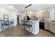 Bright kitchen boasts a center island, tile floors, stainless steel refrigerator, and unique floral wallpaper at 603 Ophelia Dr, Avon, IN 46123