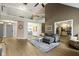 Open-concept living room with a gray sofa, open staircase, and views of the dining area and kitchen at 603 Ophelia Dr, Avon, IN 46123