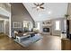 Cozy living room featuring a brick fireplace, vaulted ceiling, and modern decor at 603 Ophelia Dr, Avon, IN 46123