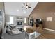 Spacious living room with a brick fireplace, vaulted ceiling, and modern furniture at 603 Ophelia Dr, Avon, IN 46123