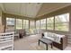 Relaxing sunroom with comfortable seating, a swing, and lots of natural light from the large windows at 603 Ophelia Dr, Avon, IN 46123