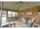 Bright sunroom featuring a hanging swing, neutral carpet, exposed brick, and a vaulted ceiling at 603 Ophelia Dr, Avon, IN 46123