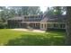 Rear exterior view features patio for outdoor enjoyment with lush green lawn at 6205 Bramshaw Rd, Indianapolis, IN 46220