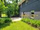 Back exterior view with patio area and manicured lawn at 6205 Bramshaw Rd, Indianapolis, IN 46220