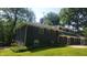 Back exterior view featuring manicured lawn at 6205 Bramshaw Rd, Indianapolis, IN 46220