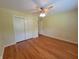 Bedroom with hardwood floors, a ceiling fan, closet, and bright window at 6205 Bramshaw Rd, Indianapolis, IN 46220