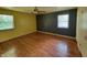 Spacious bedroom featuring hardwood floors, ample natural light, and a ceiling fan at 6205 Bramshaw Rd, Indianapolis, IN 46220