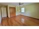 Bedroom with hardwood floors, a ceiling fan, a closet, and a bright window at 6205 Bramshaw Rd, Indianapolis, IN 46220