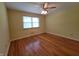 Bedroom with hardwood floors, a ceiling fan, and a bright window at 6205 Bramshaw Rd, Indianapolis, IN 46220