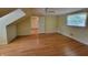 Bedroom with hardwood floors, ceiling fan, and bright window at 6205 Bramshaw Rd, Indianapolis, IN 46220