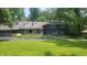 Charming two-story home featuring a beautifully landscaped front yard and a classic architectural design at 6205 Bramshaw Rd, Indianapolis, IN 46220
