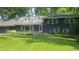 Inviting two-story residence with a lush green lawn and colorful garden beds enhancing its curb appeal at 6205 Bramshaw Rd, Indianapolis, IN 46220