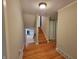 Hallway with hardwood floors and view to stairs and kitchen at 6205 Bramshaw Rd, Indianapolis, IN 46220
