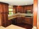 Elegant kitchen featuring dark wood cabinets, modern stainless steel appliances and ample counter space at 6205 Bramshaw Rd, Indianapolis, IN 46220