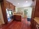 Well-appointed kitchen featuring dark wood cabinets, double ovens and a convenient breakfast bar at 6205 Bramshaw Rd, Indianapolis, IN 46220