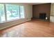 Inviting living room features a brick fireplace, hardwood floors and a large picture window at 6205 Bramshaw Rd, Indianapolis, IN 46220