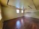Bright living room offering hardwood floors, a ceiling fan, track lighting, and natural light from two windows at 6205 Bramshaw Rd, Indianapolis, IN 46220