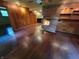 Living room features hardwood floors, brick fireplace, built-in shelves and cabinets, and a ceiling fan at 6205 Bramshaw Rd, Indianapolis, IN 46220