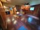 Spacious living room with hardwood floors, a brick fireplace, built-in shelves, and a ceiling fan at 6205 Bramshaw Rd, Indianapolis, IN 46220