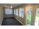Bright sunroom featuring multiple windows with blinds, a ceiling fan, and access to the backyard at 6205 Bramshaw Rd, Indianapolis, IN 46220