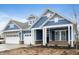 Two-story home with blue siding, white trim, and a three-car garage at 15786 Vitalize Run, Fishers, IN 46040