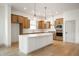 Modern kitchen with white island, wood cabinets, and stainless steel appliances at 15786 Vitalize Run, Fishers, IN 46040