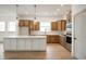 Modern kitchen with island, stainless steel appliances, and light wood cabinets at 15786 Vitalize Run, Fishers, IN 46040