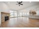 Spacious living room with hardwood floors, fireplace, and kitchen views at 15786 Vitalize Run, Fishers, IN 46040