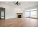 Living room with hardwood floors, fireplace, and large windows at 15786 Vitalize Run, Fishers, IN 46040