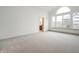 Large main bedroom with carpeted floors and an arched window at 15786 Vitalize Run, Fishers, IN 46040