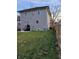 Spacious backyard featuring a well-maintained lawn, a small patio area, and a privacy fence at 2828 Robson St, Indianapolis, IN 46201