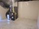 Clean basement with painted walls and a modern epoxy floor featuring the home's furnace at 2828 Robson St, Indianapolis, IN 46201
