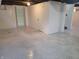 Expansive basement with speckled epoxy flooring, painted walls, and doorways at 2828 Robson St, Indianapolis, IN 46201