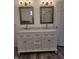 Bright bathroom featuring a double vanity with marble countertop and decorative mirrors at 2828 Robson St, Indianapolis, IN 46201