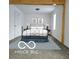 Bedroom featuring a metal bed, blue rug, and natural light at 2828 Robson St, Indianapolis, IN 46201