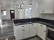 Open-concept kitchen with sleek granite countertops, white cabinets, and an adjoining dining area with plenty of natural light at 2828 Robson St, Indianapolis, IN 46201