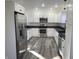 Well-lit kitchen with stainless steel appliances and white cabinets at 2828 Robson St, Indianapolis, IN 46201