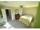 Bedroom with carpeted floor, ceiling fan, and light green accent wall at 5211 Nicodemus Dr, Plainfield, IN 46168